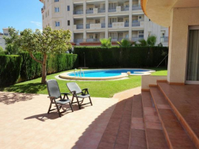 Light apartment with communal pool and walking distance to the beach